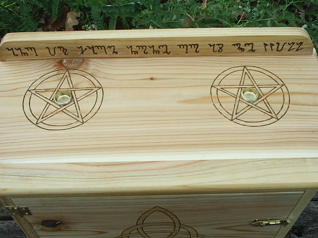 Triquetra on front cabinet door, representing the triple goddess and the three phases of a woman's life, maiden, mother, and crone.