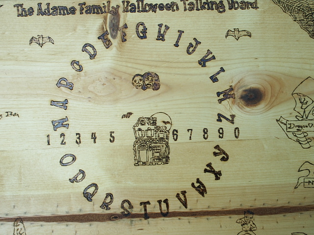 A haunted house, vampires, and bats center this board near frost type lettering and numerals