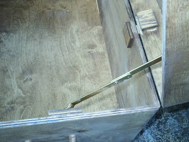 Brass lid extension to keep open while loading and unloading items from this storage chest