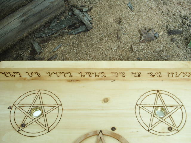 Theban script And It Harm None Do As Ye Will on this Wiccan Altar