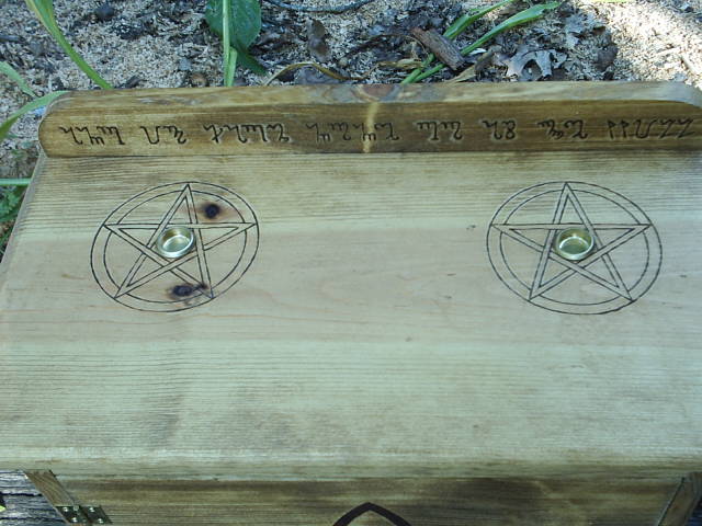 Triquetra on front cabinet door, representing the triple goddess and the three phases of a woman's life, maiden, mother, and crone.