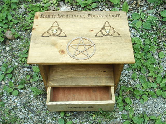 Pentagram scolled and mounted on top altar, god and goddess scrolled into the sides